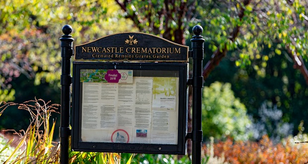 The image shows a sign with the words Newcastle Crematorium written upon it.
