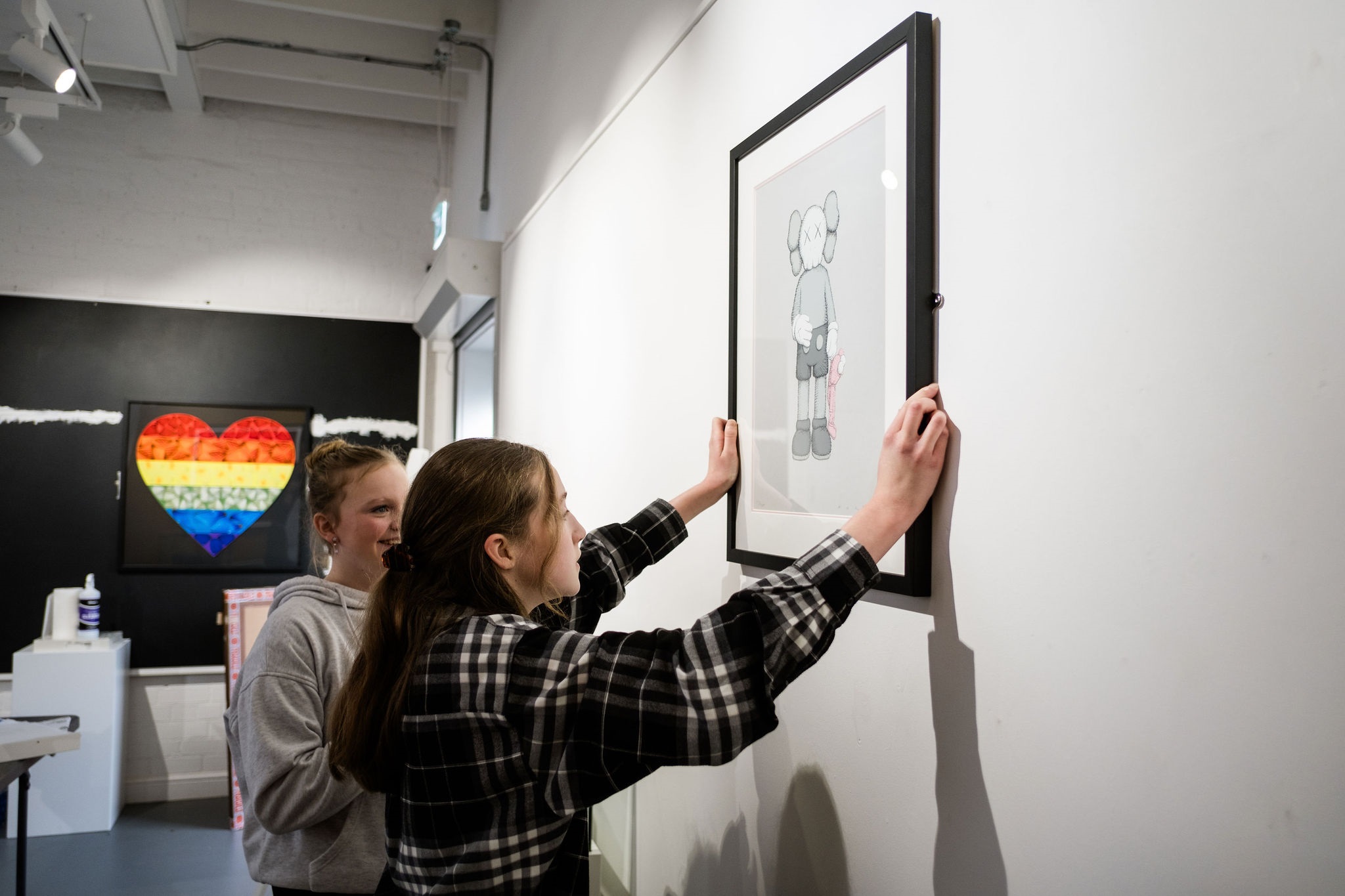 The image shows pupils preparing an exhibition of images.