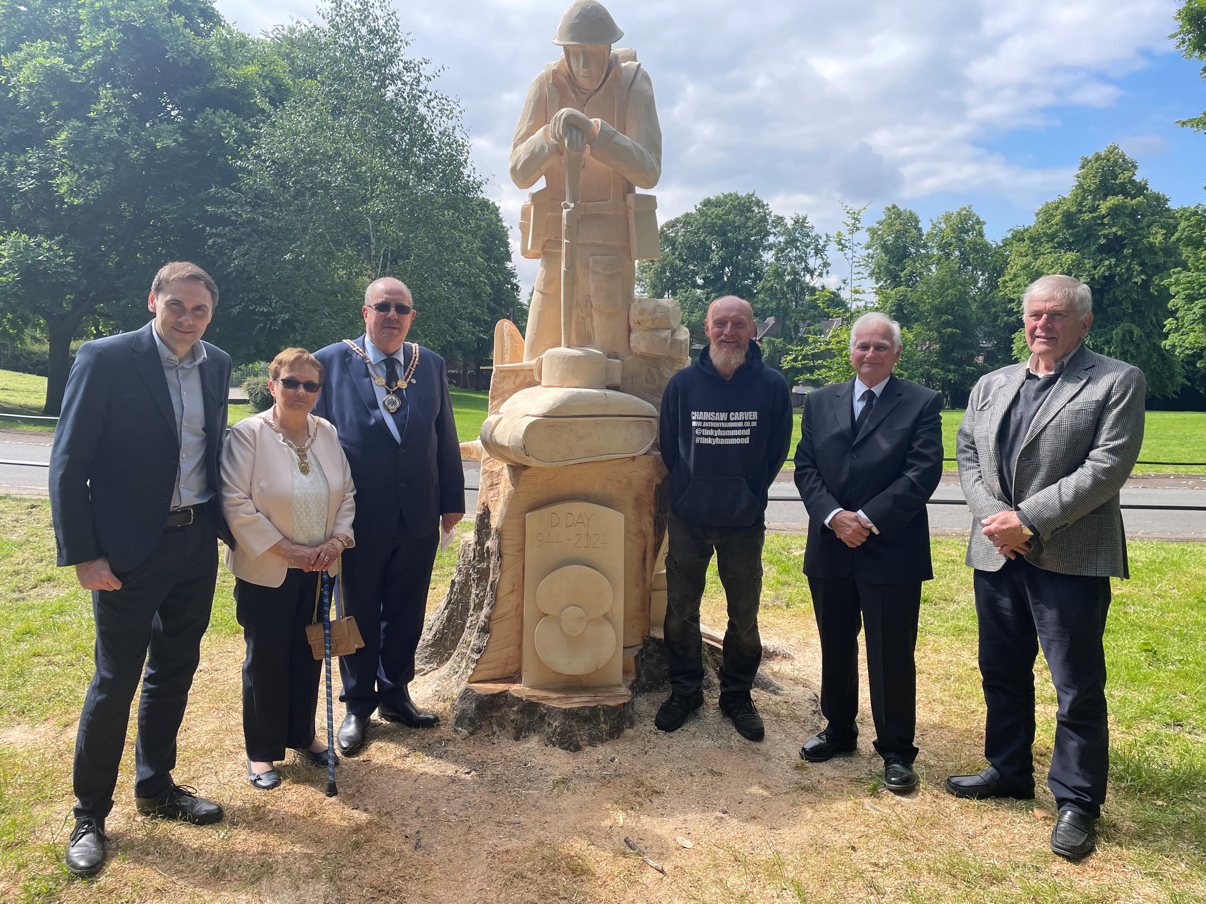 Pictured, left to right, with the D-Day carving at Brampton Park are Council Leader Simon Tagg, Mayoress Beatrice Panter, Mayor Barry Panter, sculptor Anthony Hammond and North Staffs Model Engineering Society members Mike Barnett and Rodger Taylor.