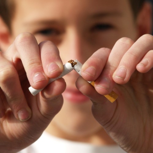 A child snaps a cigarette in two